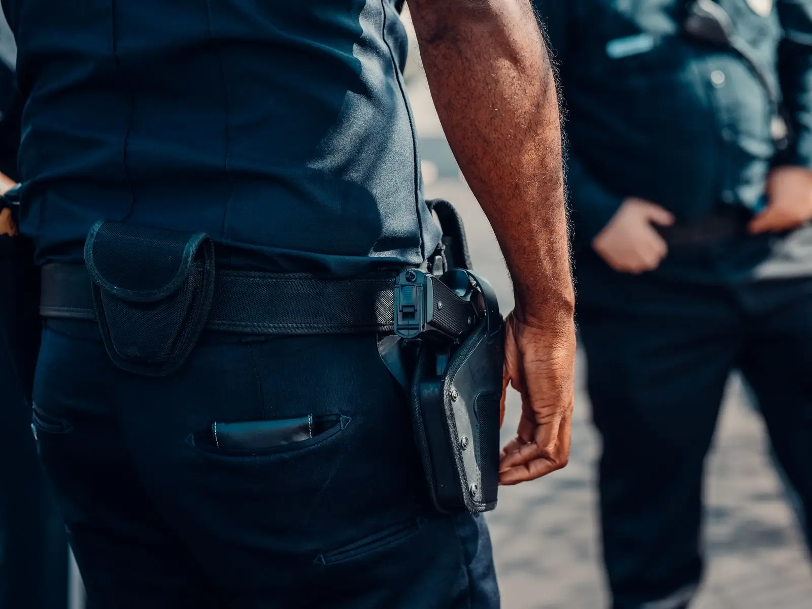 Close-up of a handgun secured in a belt holster